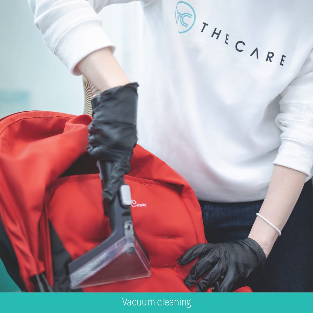 The Care employee vacuum cleaning a red Came backpack