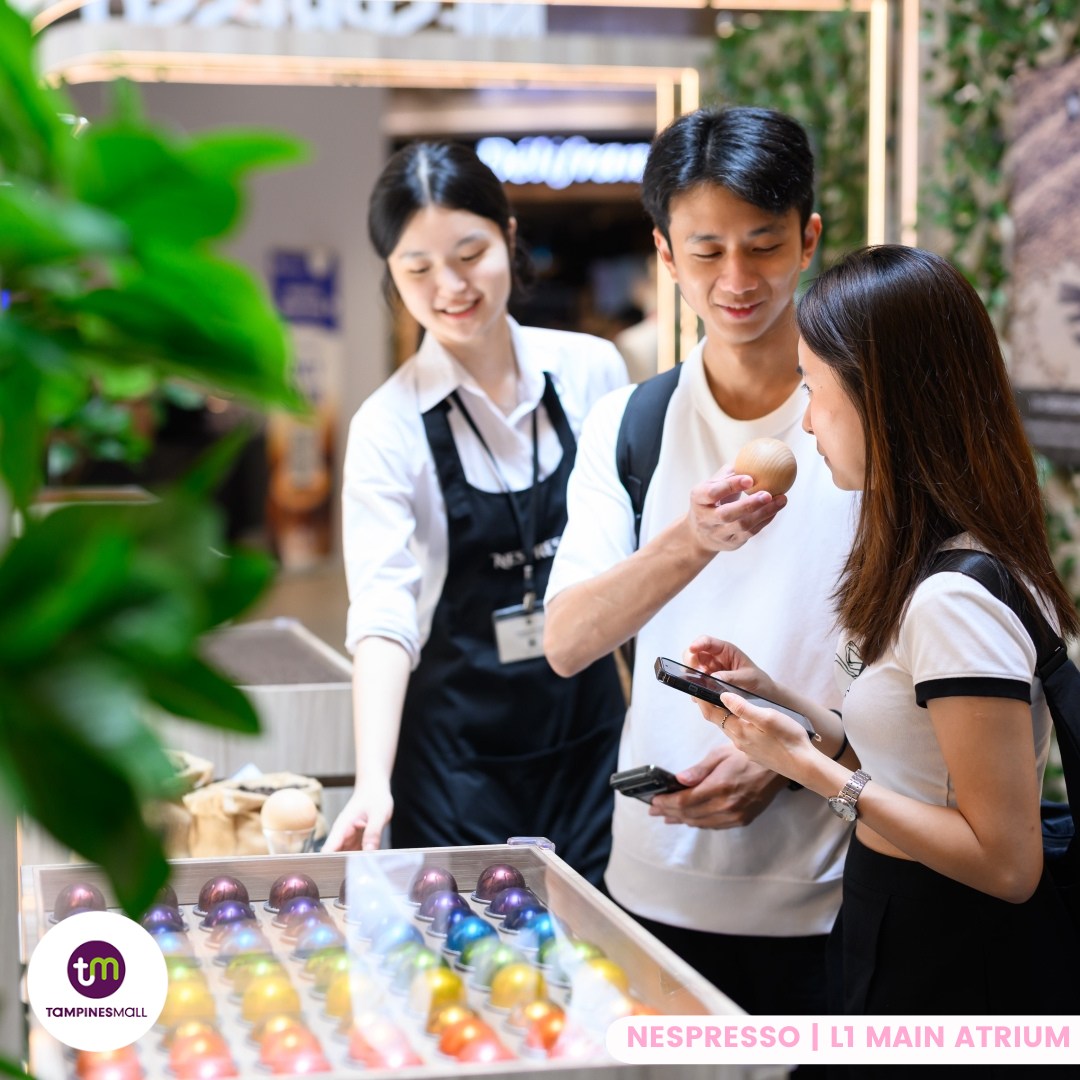 Visitors enjoying complimentary Nespresso coffee.