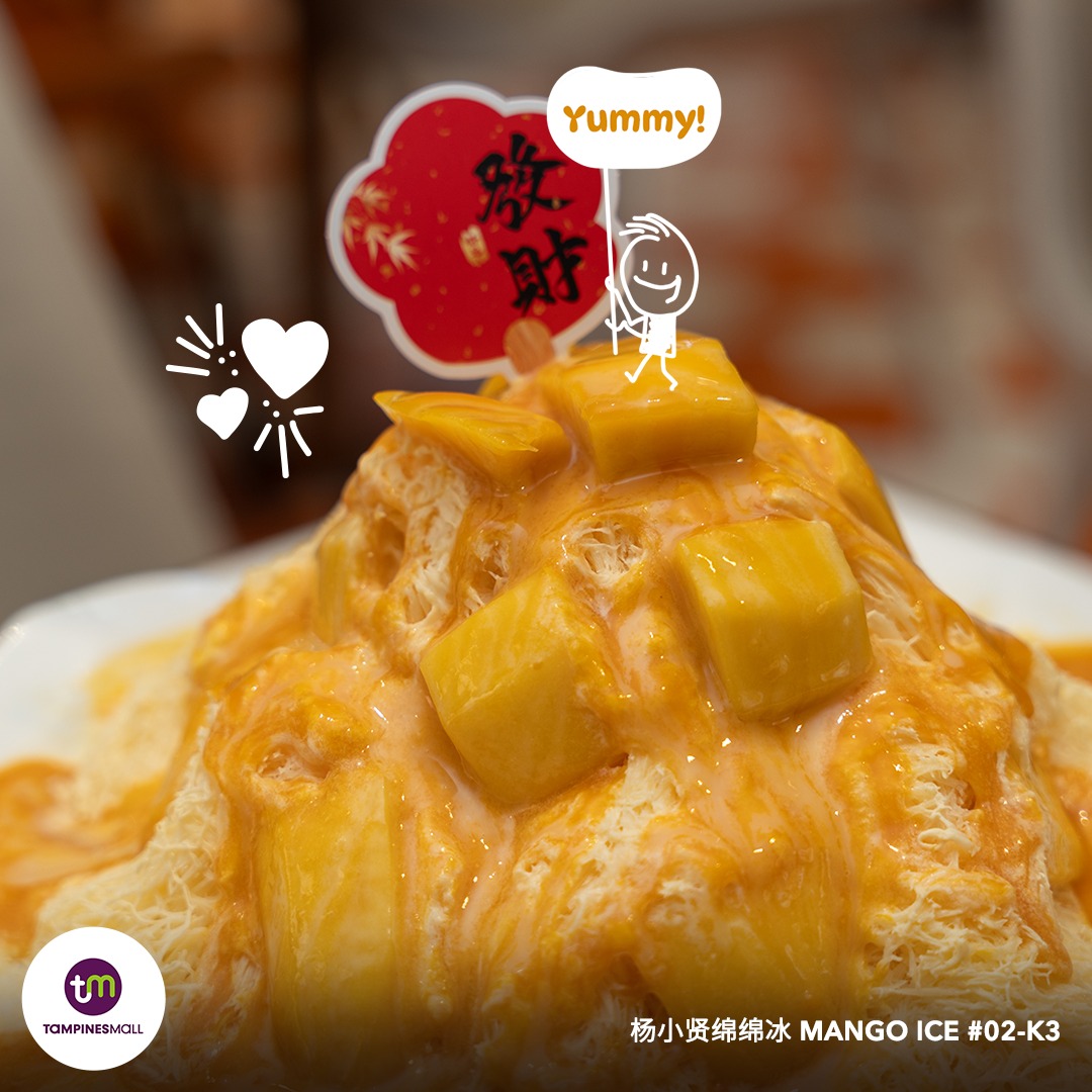A towering serving of Super Mango Cotton Ice with fresh mango chunks
