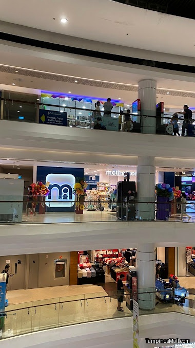 An interior shot of a mall with multiple levels and a Mothercare store.